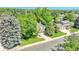 Well maintained house surrounded by mature trees and landscaping, with a welcoming and well-kept appearance at 5543 S Kenton Ct, Englewood, CO 80111