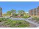 Lush courtyard with seating, mature trees, and landscaping at 955 Eudora St # 203E, Denver, CO 80220