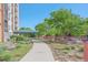 Manicured walkway and flower beds with garden lead to the building entrance at 955 Eudora St # 203E, Denver, CO 80220