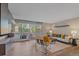 Open living room with hardwood floors, neutral tones, and a balcony view at 955 Eudora St # 203E, Denver, CO 80220