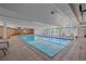 Indoor pool with lounge chairs and a brick accent wall offers a relaxing recreational space at 955 Eudora St # 203E, Denver, CO 80220