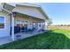Outdoor patio area with seating, grill, and a well-manicured lawn at 11499 County Road 40 1/2 Rd, Platteville, CO 80651
