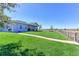 Wide backyard with a lush lawn, patio, and fenced perimeter, providing privacy and space at 11499 County Road 40 1/2 Rd, Platteville, CO 80651