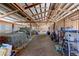 Interior view of the barn with storage for hay, equipment, and tools along the perimeter at 11499 County Road 40 1/2 Rd, Platteville, CO 80651