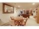 Basement featuring wood table, seating, large mirror, and partially visible entertainment area at 11499 County Road 40 1/2 Rd, Platteville, CO 80651