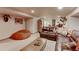 Basement living room featuring a large leather sofa, bean bag chair, and decorative accents at 11499 County Road 40 1/2 Rd, Platteville, CO 80651