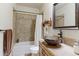Cozy bathroom featuring shower and tub, vanity, tile backsplash, and an eye-catching sink at 11499 County Road 40 1/2 Rd, Platteville, CO 80651