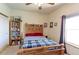 Bedroom featuring a window, carpet, a closet with a sliding door, and personal touches at 11499 County Road 40 1/2 Rd, Platteville, CO 80651