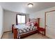 Cozy bedroom with wooden bed frame, patterned quilt, and natural light from window at 11499 County Road 40 1/2 Rd, Platteville, CO 80651