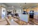 Open-concept dining room with view of the kitchen and living area, with rustic wooden table at 11499 County Road 40 1/2 Rd, Platteville, CO 80651