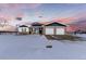Charming ranch home with a two-car garage and beautiful landscaping at sunset at 11499 County Road 40 1/2 Rd, Platteville, CO 80651