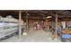 Interior view of the garage with a boat, rolling toolbox, and workbenches with tools at 11499 County Road 40 1/2 Rd, Platteville, CO 80651