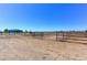Fenced horse property with a blue ranch style home in the distance on a sunny day at 11499 County Road 40 1/2 Rd, Platteville, CO 80651