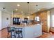 Bright kitchen with wooden cabinetry, a breakfast bar, and modern appliances at 11499 County Road 40 1/2 Rd, Platteville, CO 80651