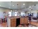 Open kitchen with views of living and dining areas, featuring wood cabinets at 11499 County Road 40 1/2 Rd, Platteville, CO 80651