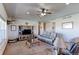 Comfortable living room featuring a ceiling fan, TV, and plush leather furniture at 11499 County Road 40 1/2 Rd, Platteville, CO 80651