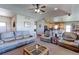 Open living room leading to a dining area and kitchen, with comfortable sofas and chairs at 11499 County Road 40 1/2 Rd, Platteville, CO 80651
