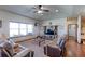 Spacious living room featuring a large window, TV, and comfortable seating at 11499 County Road 40 1/2 Rd, Platteville, CO 80651