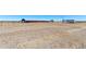 Gravel lot showing a horse barn and trailer parking space in the background on sunny day at 11499 County Road 40 1/2 Rd, Platteville, CO 80651