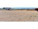 Gravel lot showing potential for multiple uses, with trailer in background on sunny day at 11499 County Road 40 1/2 Rd, Platteville, CO 80651