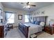 Bright main bedroom featuring carpet, windows with curtains, and rustic wood accents and furniture at 11499 County Road 40 1/2 Rd, Platteville, CO 80651