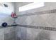 Shower featuring tile surround, shower head, built-in shelf, and accent tile at 11499 County Road 40 1/2 Rd, Platteville, CO 80651