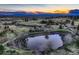 Aerial view showcasing a calm pond reflecting the picturesque sky and landscape at 10426 Tomahawk Rd, Parker, CO 80138