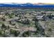 Scenic aerial view of the expansive acreage, pond, and surrounding landscape at 10426 Tomahawk Rd, Parker, CO 80138