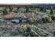 An aerial view showcases the aged farm home and landscape with a long dirt driveway and trees at 10426 Tomahawk Rd, Parker, CO 80138