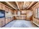 Rustic kitchen featuring wood cabinetry, brick flooring, and a window above the sink at 10426 Tomahawk Rd, Parker, CO 80138