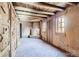 Adobe living room showcases wood beamed ceiling and fireplace in a home, creating a cozy and rustic retreat at 10426 Tomahawk Rd, Parker, CO 80138