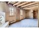 Adobe living room showcases wood beamed ceiling and brick floors in a home, creating a cozy retreat at 10426 Tomahawk Rd, Parker, CO 80138