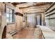 Inviting living room featuring exposed beams, rustic brick, and built-in shelving at 10426 Tomahawk Rd, Parker, CO 80138