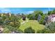 The backyard of this property features mature landscaping, a creek bed, and views of the mountains in the distance at 4515 W 107Th Cir, Westminster, CO 80031