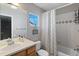 Bathroom with a shower-tub combo, white shower curtain, and vanity with a window at 4515 W 107Th Cir, Westminster, CO 80031