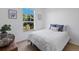 Bright bedroom with a large window and blue accents; adorned with plants and artwork at 4515 W 107Th Cir, Westminster, CO 80031