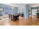 Bright dining room features a chandelier, hardwood floors, and a large window providing natural light at 4515 W 107Th Cir, Westminster, CO 80031