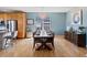 Dining area with hardwood floors, a stylish chandelier, and a large window for natural lighting at 4515 W 107Th Cir, Westminster, CO 80031