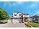Inviting two-story home showcasing a three-car garage and charming stone and siding exterior at 4515 W 107Th Cir, Westminster, CO 80031
