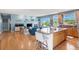 Open living space featuring a kitchen island, cozy living room, and hardwood floors at 4515 W 107Th Cir, Westminster, CO 80031