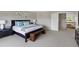 Spacious bedroom features a large bed, neutral tones, and an adjacent staircase at 4515 W 107Th Cir, Westminster, CO 80031