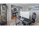 Home office with a modern desk, a large monitor, and a view into an open hallway at 4515 W 107Th Cir, Westminster, CO 80031