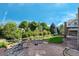 A stone patio features an outdoor fire pit and beautiful view of a green lawn with natural landscaping at 4515 W 107Th Cir, Westminster, CO 80031