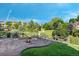 Stone patio features an outdoor fire pit, seating and a beautiful view of the green lawn and open space at 4515 W 107Th Cir, Westminster, CO 80031