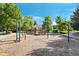 A community playground sits on a bed of mulch and features a swing set, climbing wall, and other activities at 4515 W 107Th Cir, Westminster, CO 80031