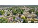 Aerial view of a blue single-story home and neighborhood with lush trees at 935 S Pecos Way, Denver, CO 80223