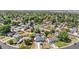 Aerial view of a blue single-story home and neighborhood with lush trees at 935 S Pecos Way, Denver, CO 80223