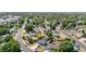 Aerial view of a blue single-story home and neighborhood with lush trees at 935 S Pecos Way, Denver, CO 80223