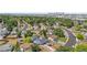 Aerial view of a blue single-story home and neighborhood with Denver skyline in background at 935 S Pecos Way, Denver, CO 80223