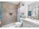 Updated bathroom featuring neutral tile, modern fixtures, and a shower-tub combination at 935 S Pecos Way, Denver, CO 80223